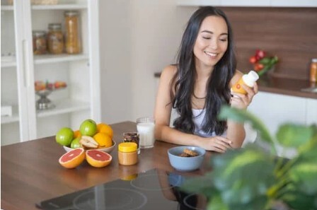 Woman holding a supplement bottle